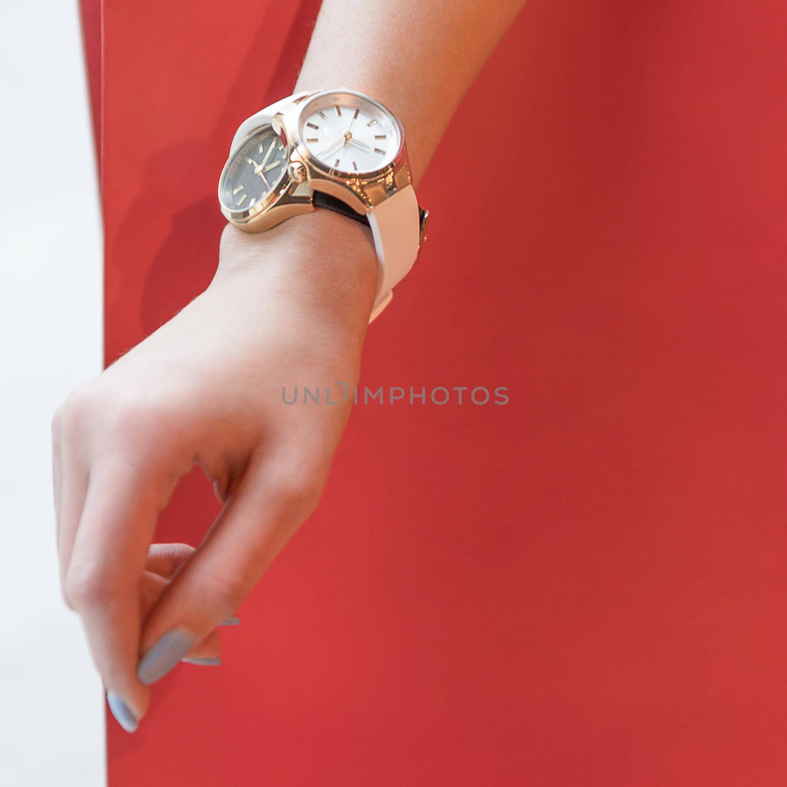 Woman sport style hand watch isolated red background
