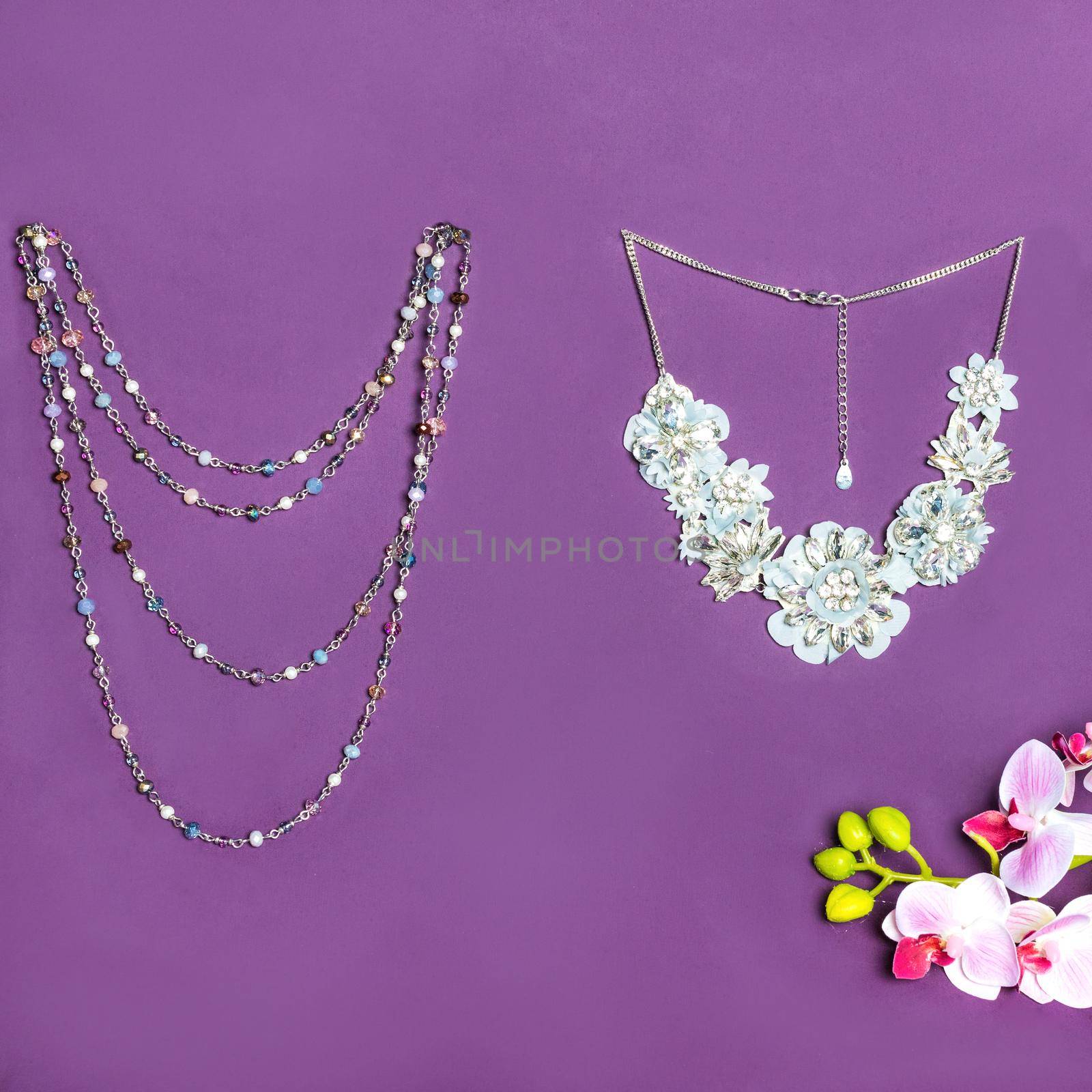 Elegant gold necklace with diamonds on purple background