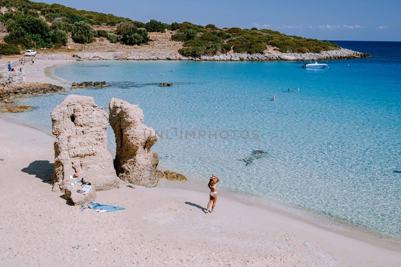 Tropical beach of Voulisma beach, Istron, Crete, Greece, couple on vacation in Greece by fokkebok