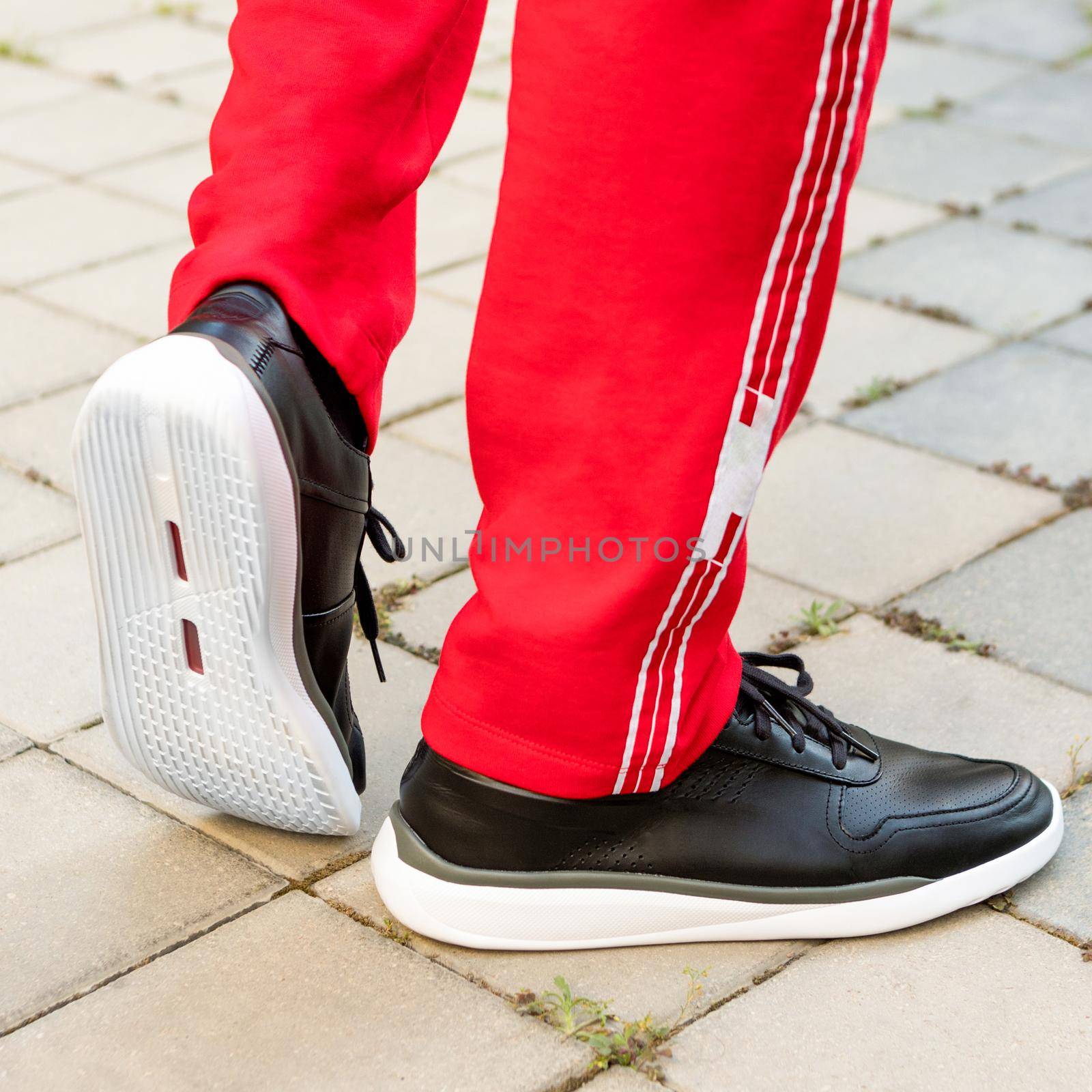 Man leather black sport sneakers close up