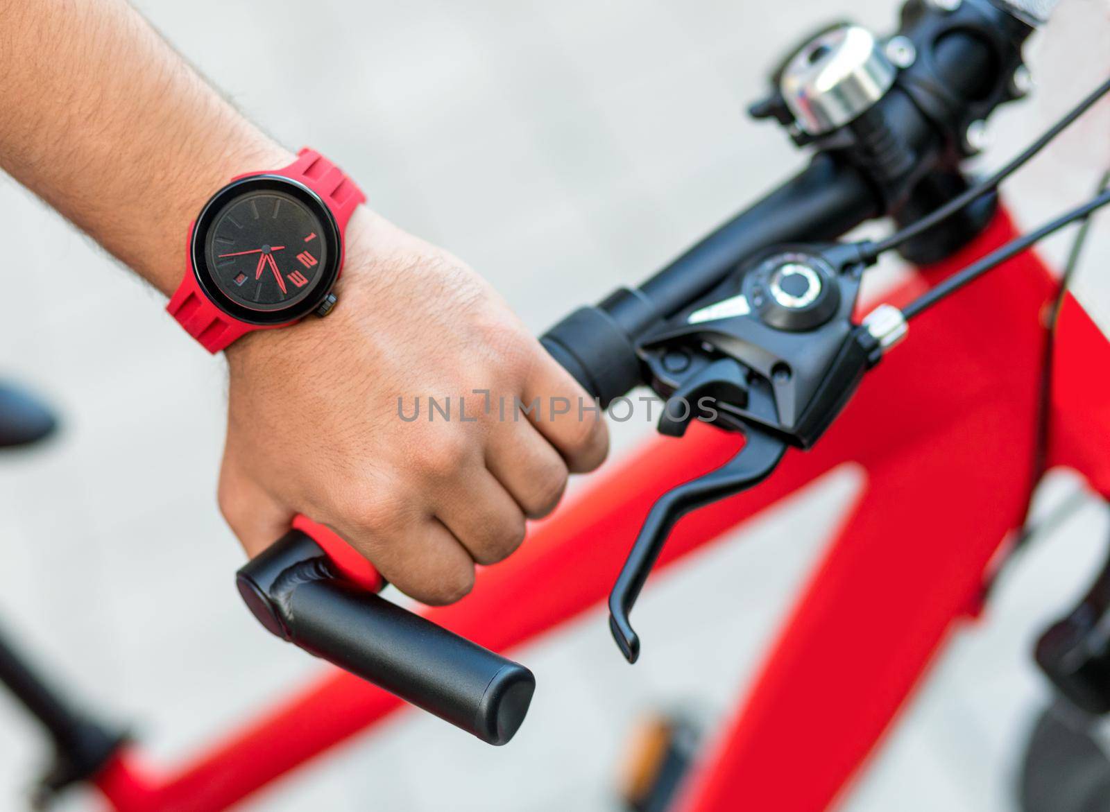 Man red bike handle grips with a red watch close up by ferhad