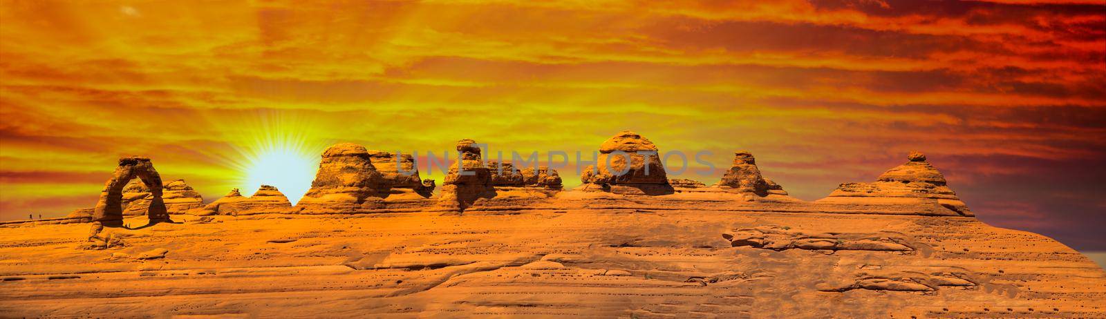 Delicate Arch panoramic view, Arches National Park. High resolution image of rock formations at sunset.