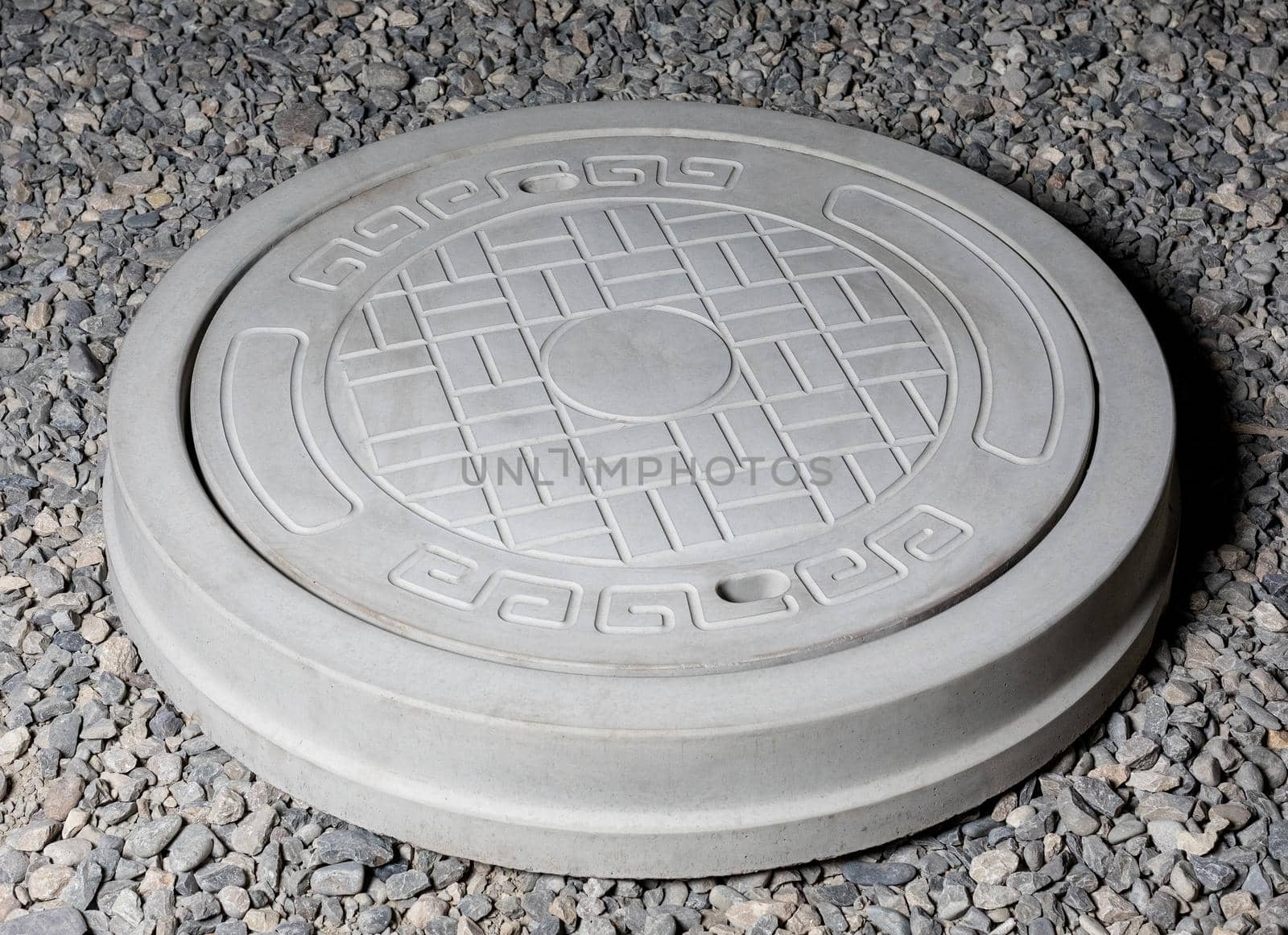 Plaster graceful stone manhole shape on the ground