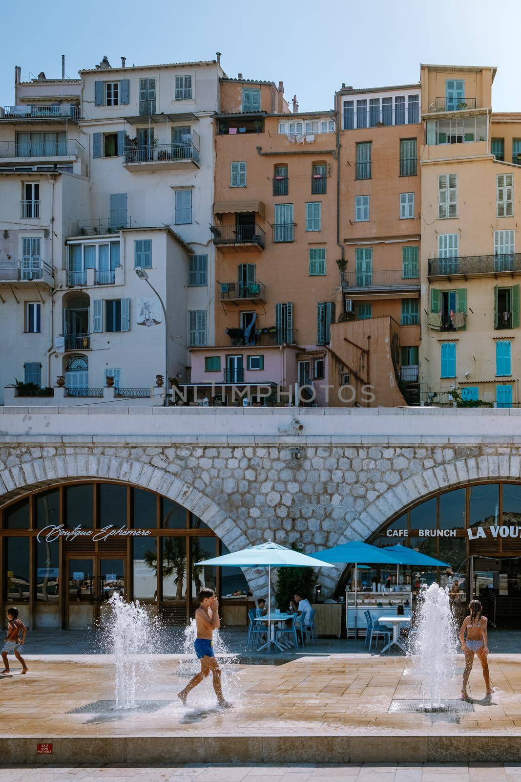 Menton France,Cote d Azur June 2020, warm hot summer day at waterfront beach and a view on old part of Menton, Provence-Alpes-Cote d'Azur, France by fokkebok