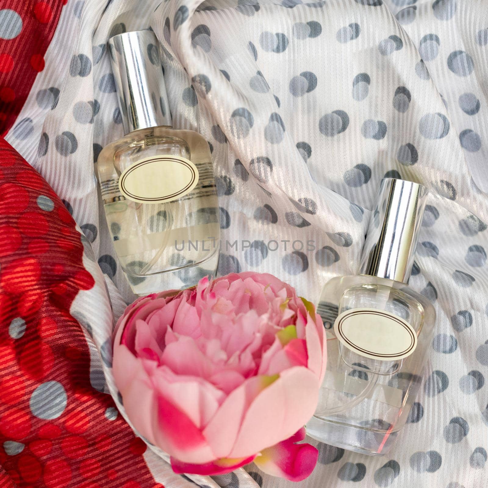 Perfume flacon with rose on the colorful background