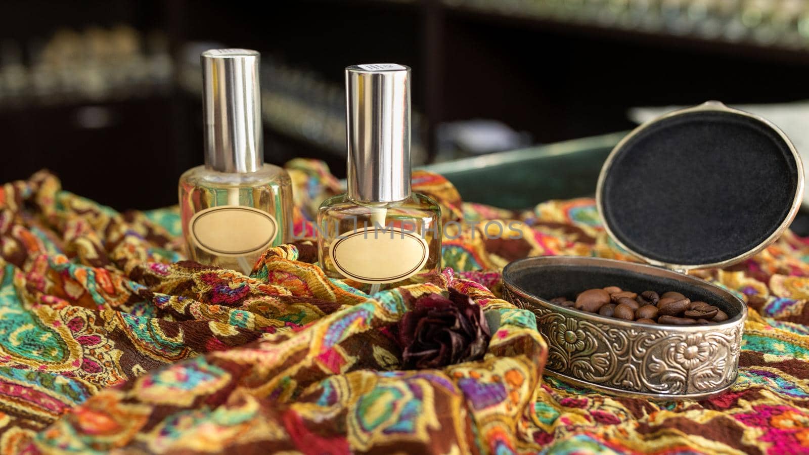 Perfume flacon with coffee on the colorful cloth