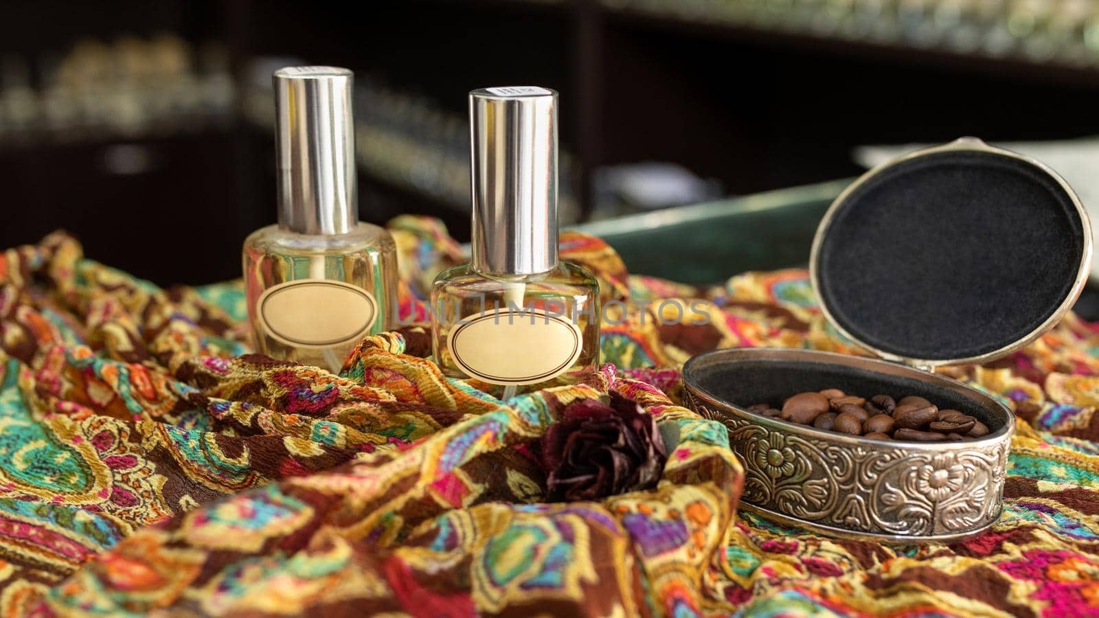 Perfume flacon with coffee on the colorful cloth by ferhad