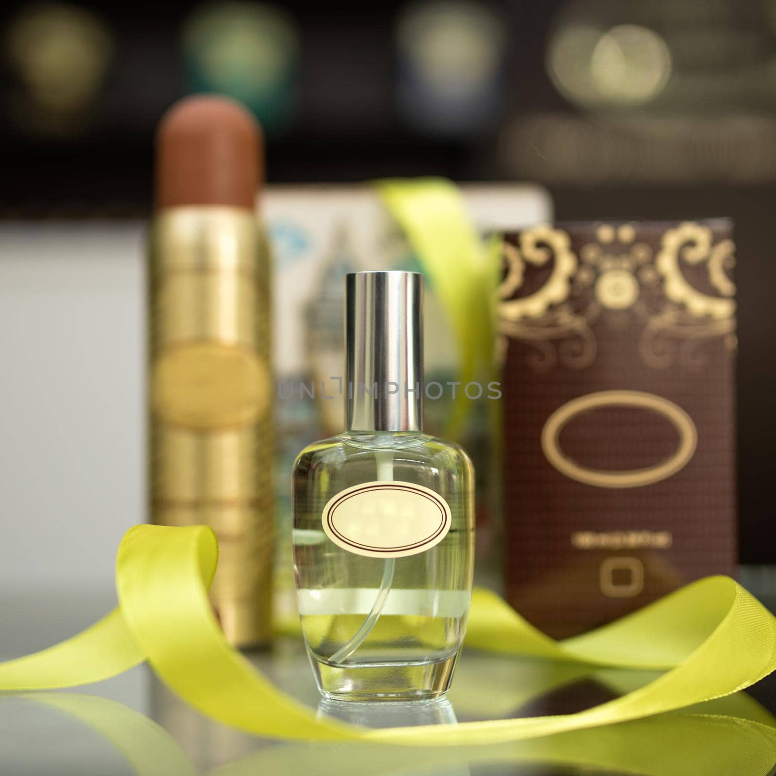 Perfume flacon with box, deodorant on the blur background