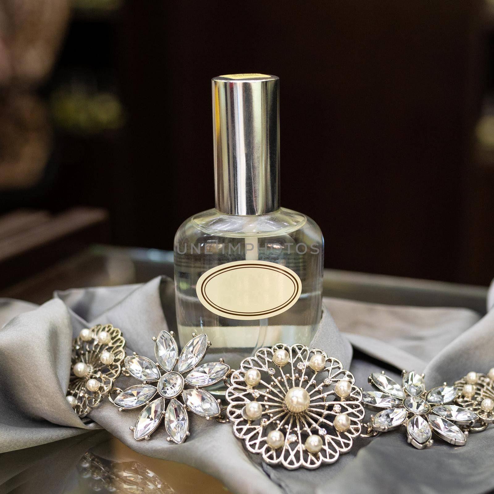 Perfume flacon with jewellery on the white background by ferhad