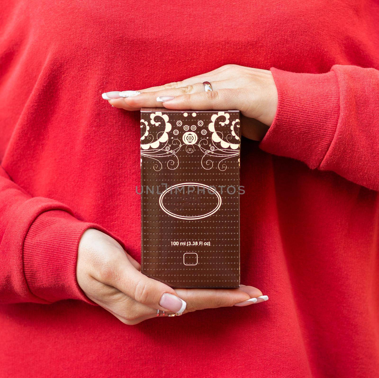 Woman holding perfume flacon box with red cloth by ferhad