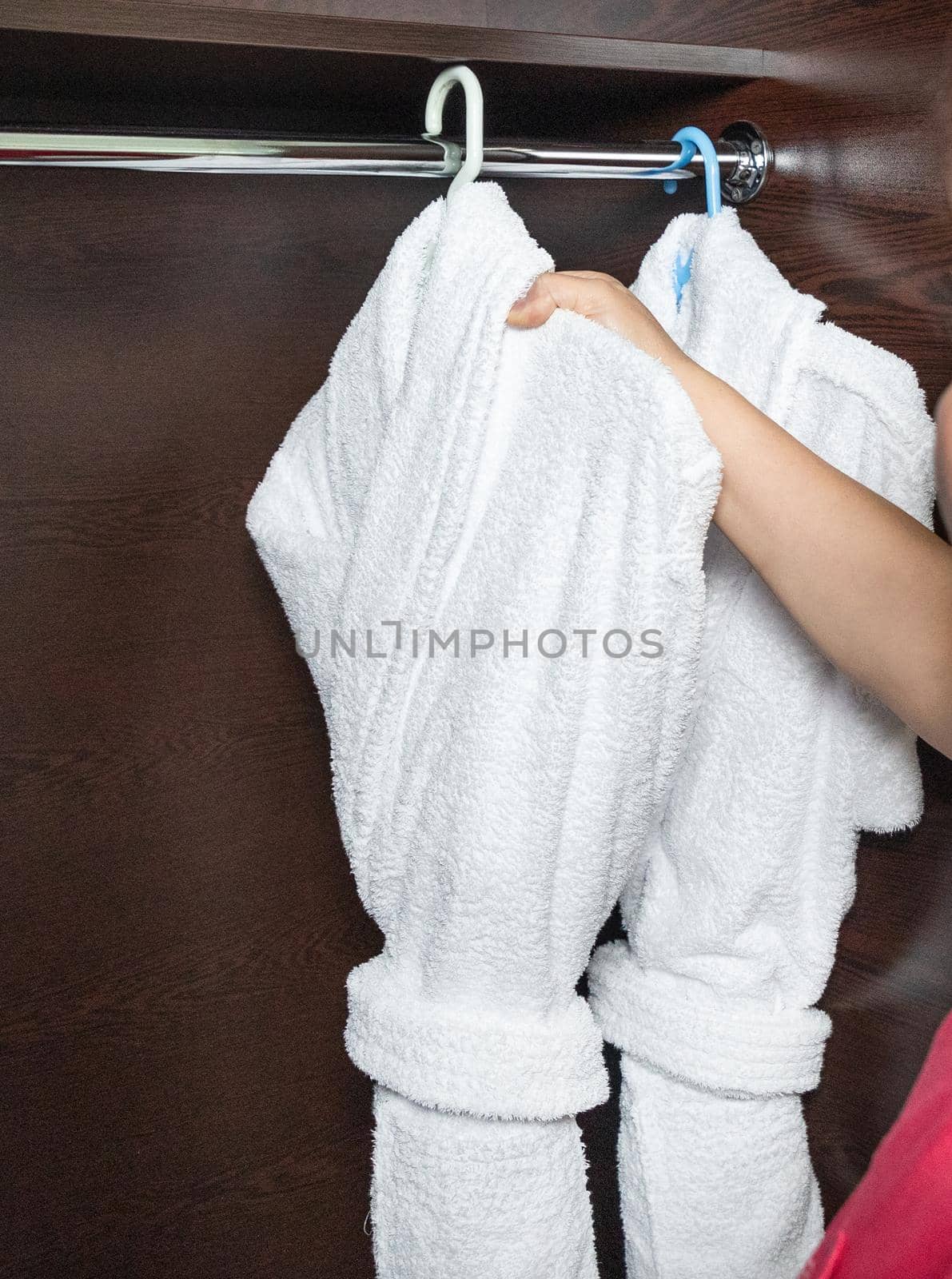 Hotel room service, woman taking out bathrobe