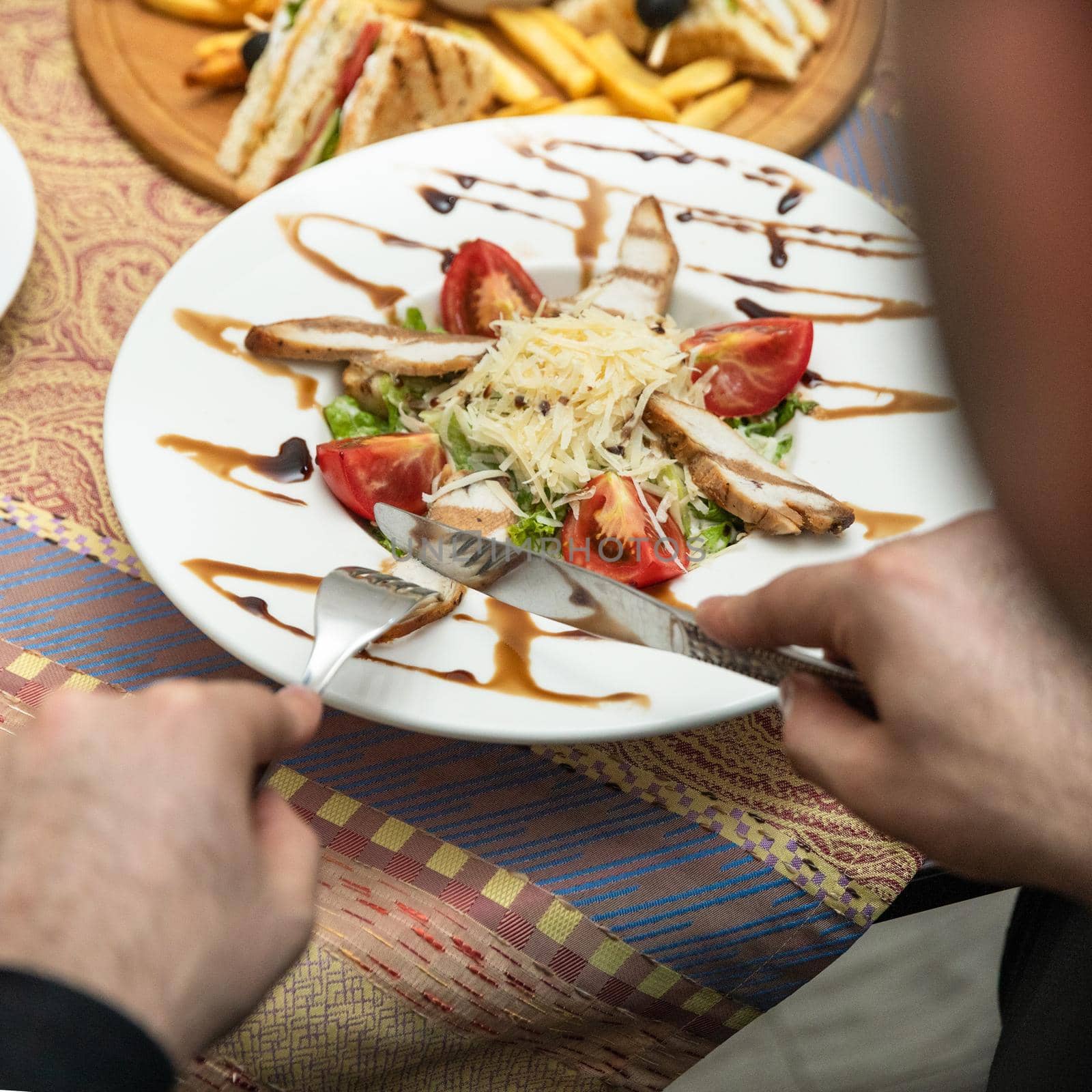 Man eating beautiful chicken salad, top view