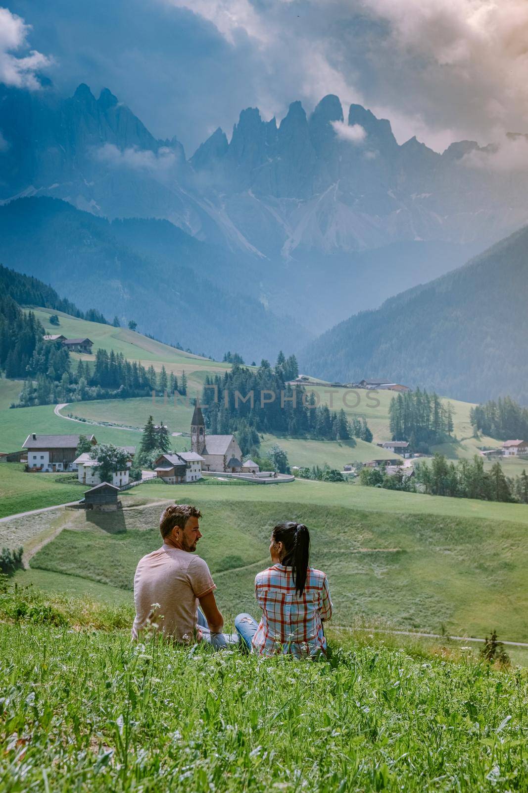 couple on vacation in the Dolomites Italy, Santa Magdalena Village in Dolomites area Italy Val di Funes by fokkebok