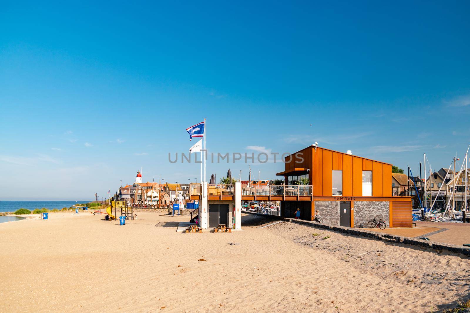 Urk Netherlands August 2020, harbor and lighthouse near the beach on a bright summer day Flevoland Urk Netherlands Europe, new restaurant pavilion on the beach