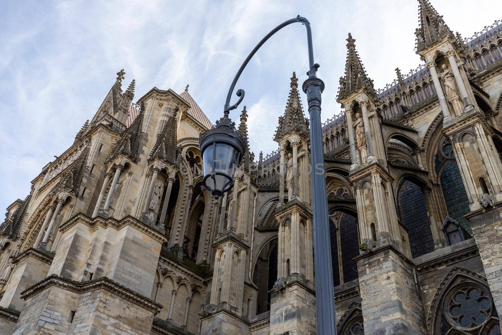 Low angle view at cathedral Notre Dame in Reims, France with street lamp in foreground