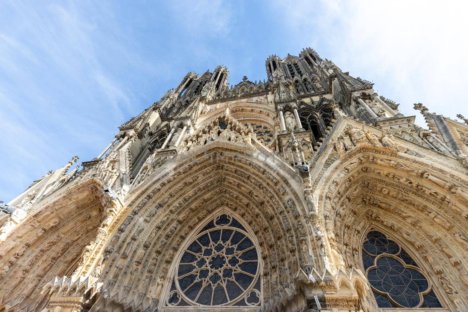 Low angle view at the front of cathedral Notre Dame in Reims, France