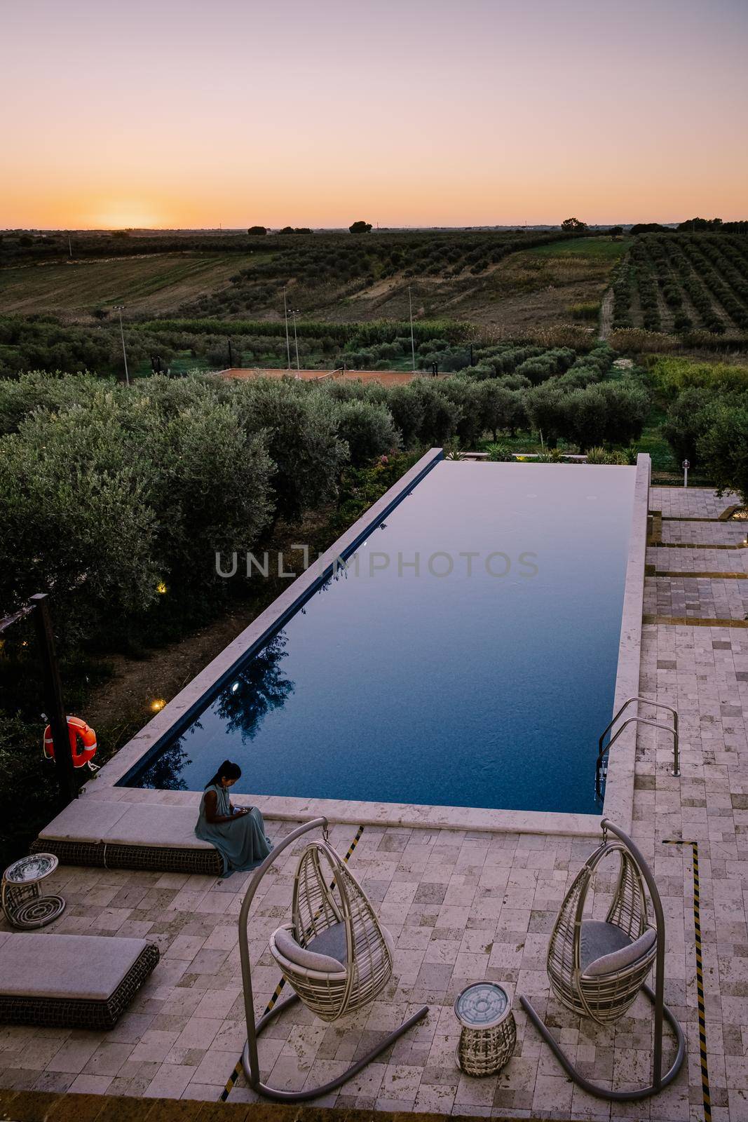 Luxury resort with a view over the wine field in Selinunte Sicily Italy. infinity pool with a view over wine fields in Sicilia, woman on vacation luxury resort