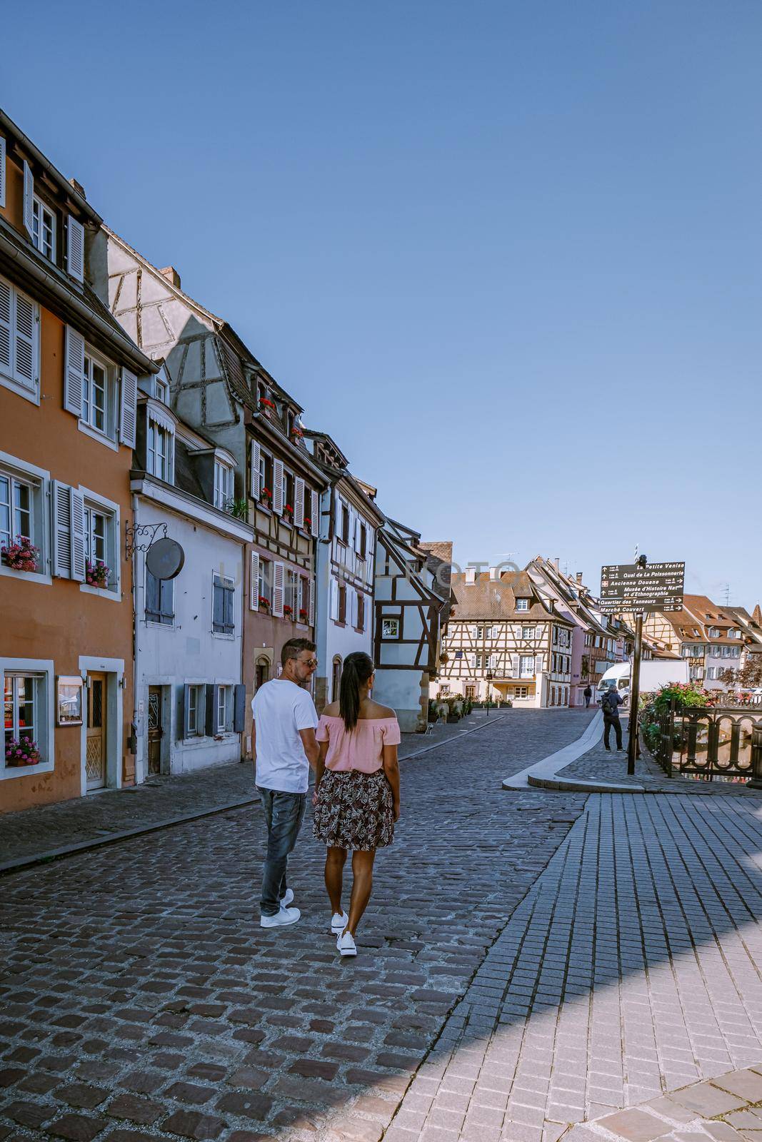 couple on city trip Colmar, Alsace, France. Petite Venice, water canal and traditional half timbered houses. Colmar is a charming town in Alsace, France. Beautiful view of colorful romantic city Colmar, France, Alsace by fokkebok