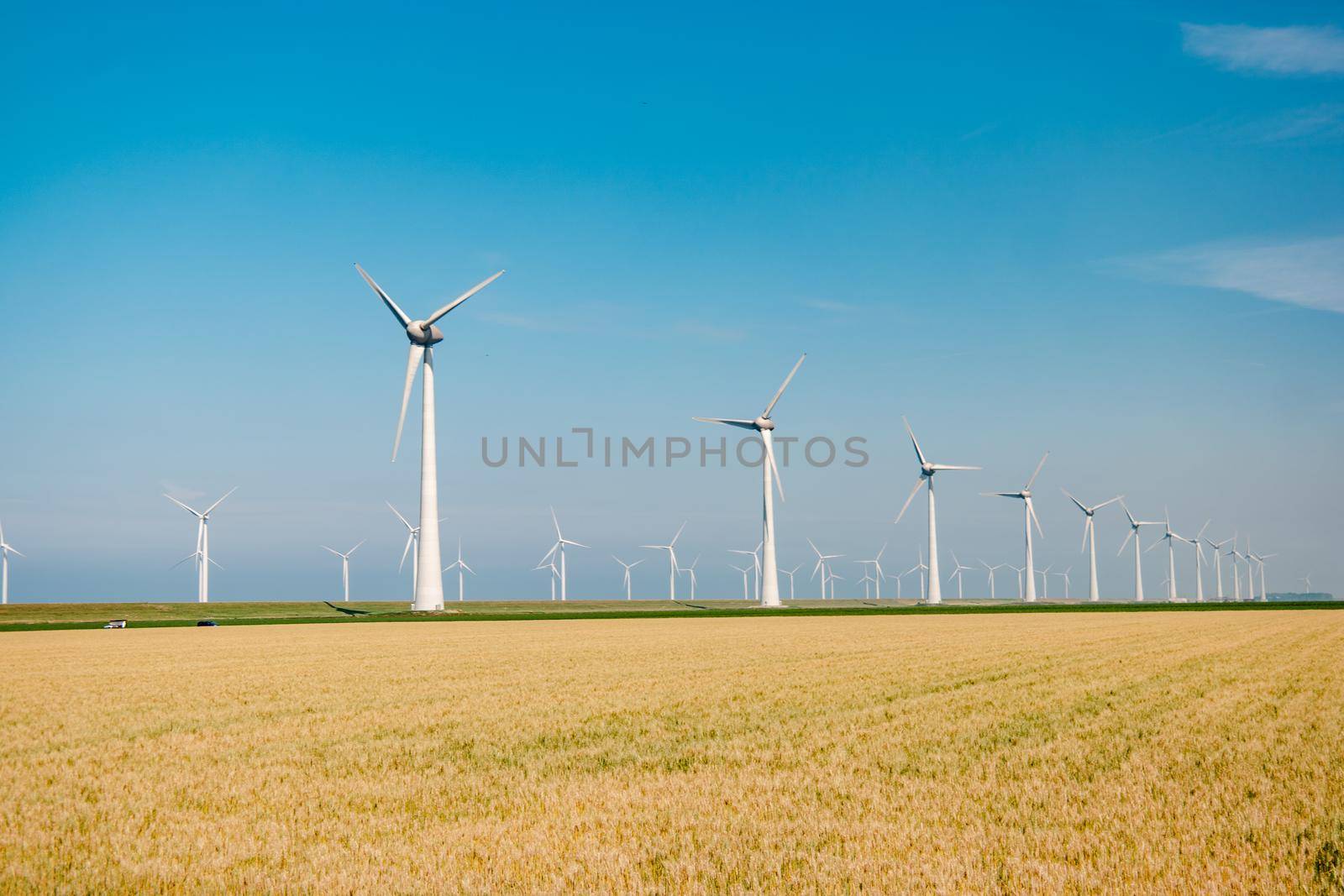 offshore windmill park with stormy clouds and a blue sky, windmill park in the ocean by fokkebok