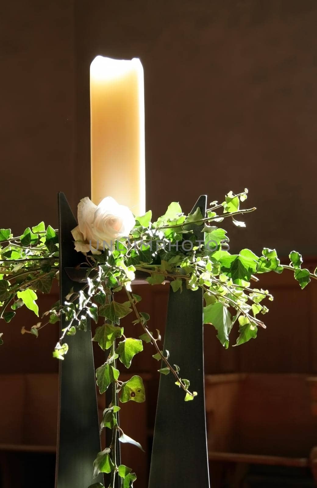 Decorated candle in a church with backlighting