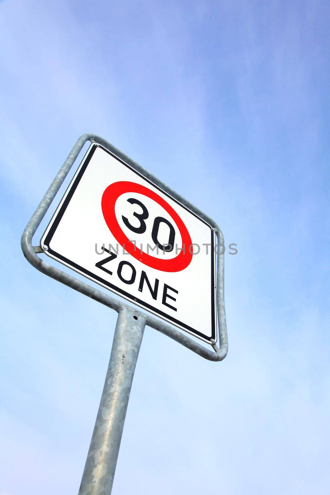 Speed limit traffic sign in front of a blue sky with copy space by Kasparart