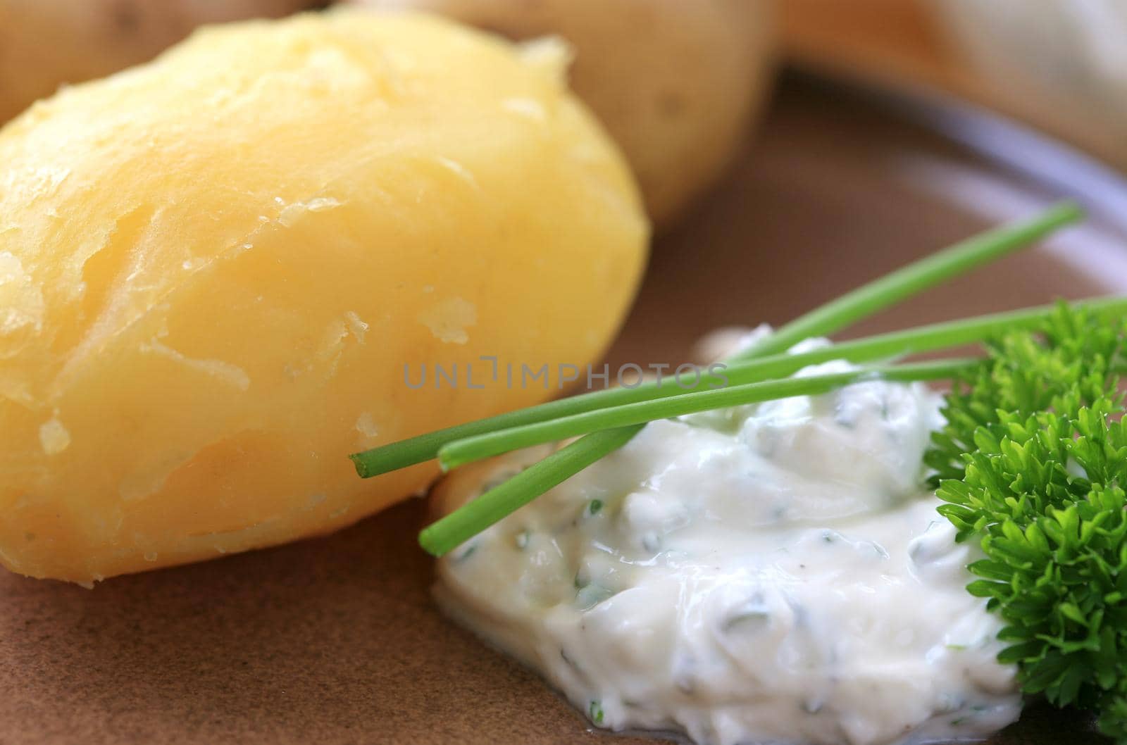 Peeled baked potato with sour cream and herbs