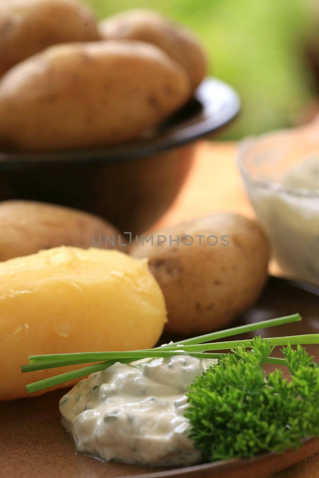 Peeled baked potato with sour cream and herbs by Kasparart