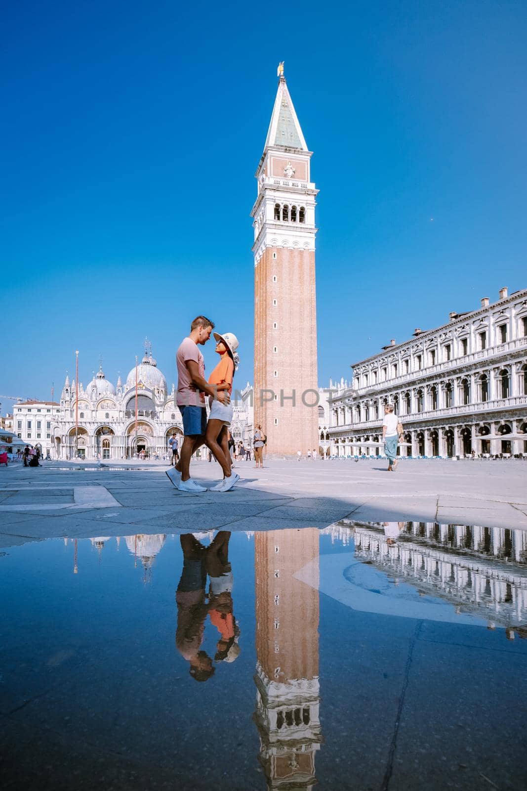 couple men and woman on a city trip to Venice Italy, colorful streets with canals Venice. Europe