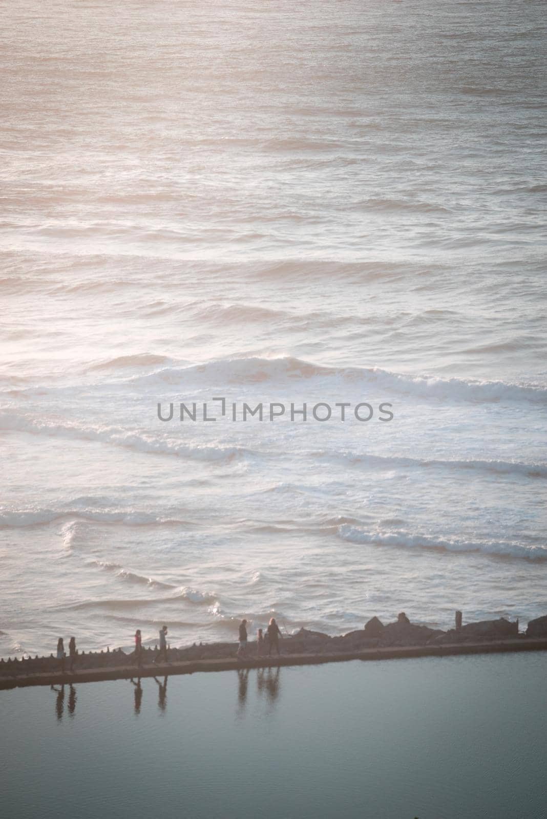 A reflection pool beside the ocean at sunset.