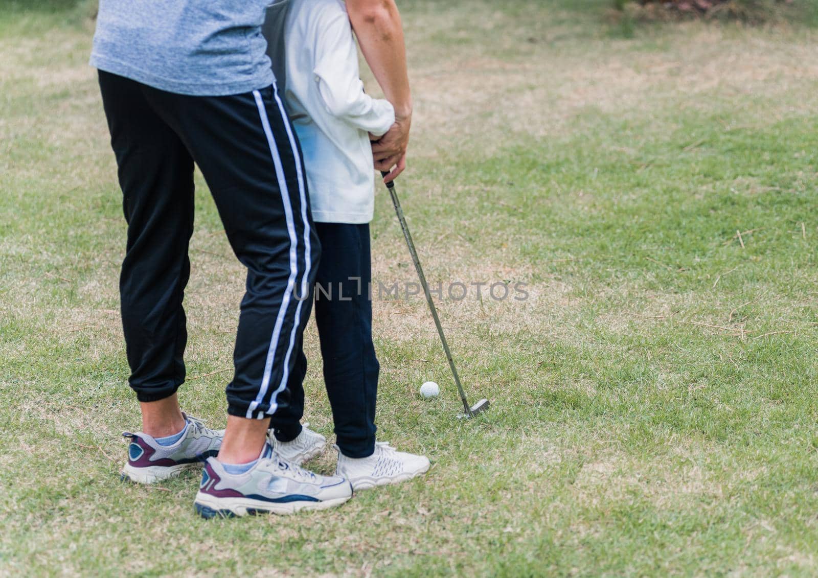 father support teaching training daughter to play perfect golf by Sorapop
