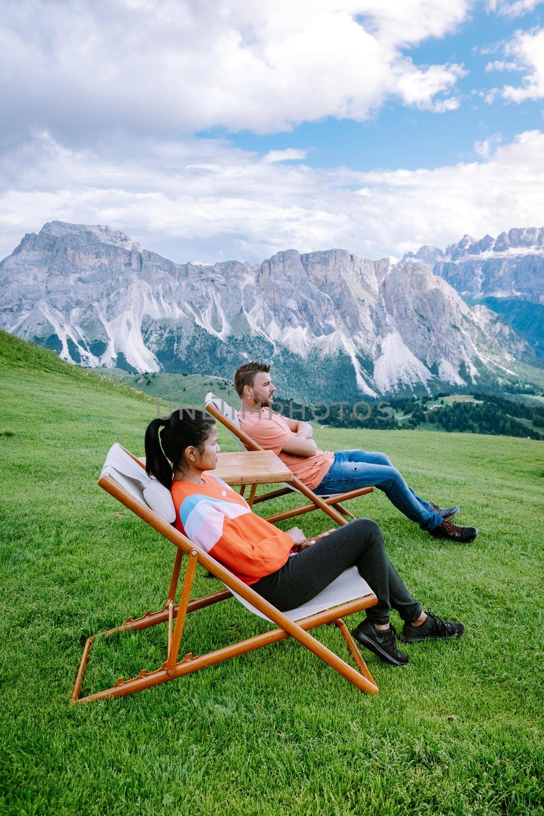 couple on vacation hiking in the Italien Dolomites, Amazing view on Seceda peak. Trentino Alto Adige, Dolomites Alps, South Tyrol, Italy, Europe. Seceda Peak