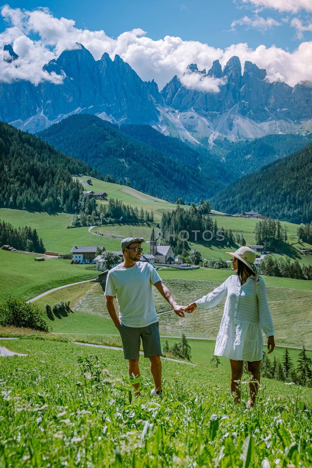 couple on vacation Santa Magdalena Village in Dolomites area Italy, couple on vacation Val Di Funes Italian Dolomites by fokkebok