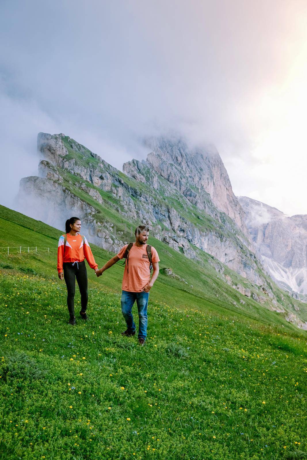 couple on vacation hiking in the Italien Dolomites, Amazing view on Seceda peak. Trentino Alto Adige, Dolomites Alps, South Tyrol, Italy, Europe. Seceda Peak