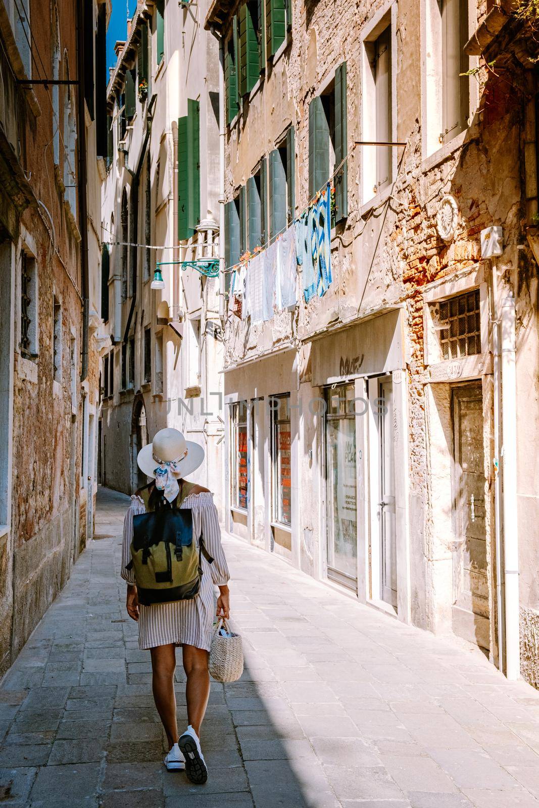 woman on city trip in Venice, Beautiful venetian street in summer day, Italy Venice by fokkebok