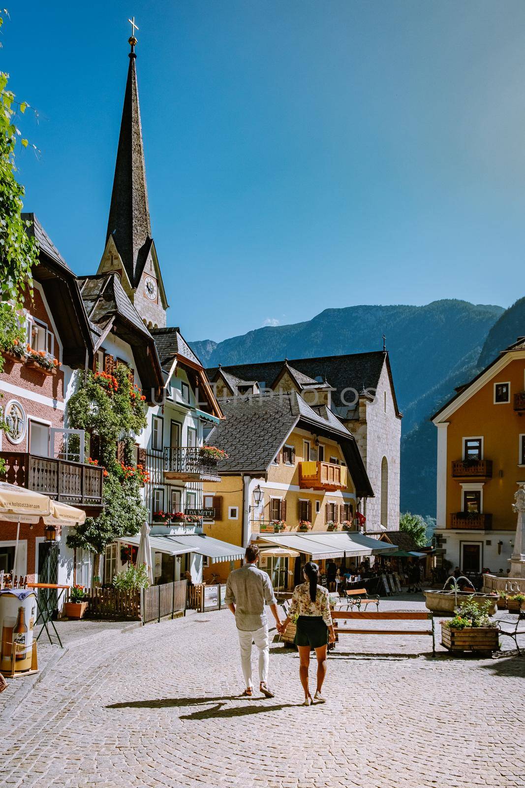 couple visit during summer vacation Hallstatt village on Hallstatter lake in Austrian Alps Austria Europe
