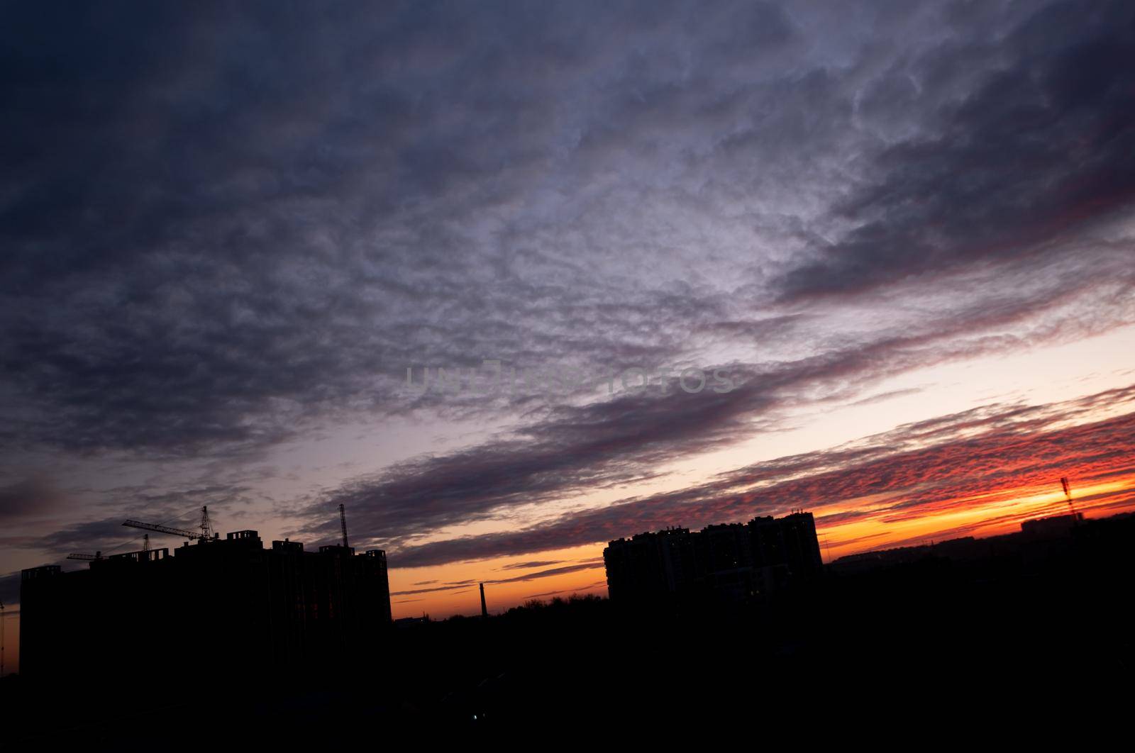 Sunset over the city in the inclined horizon. Beautiful sky after sunset.