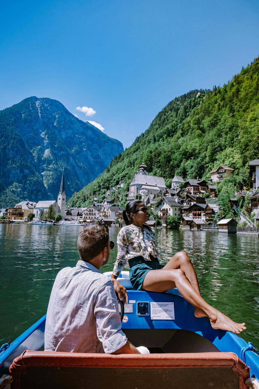couple visit Hallstatt village on Hallstatter lake in Austrian Alps Austria by fokkebok