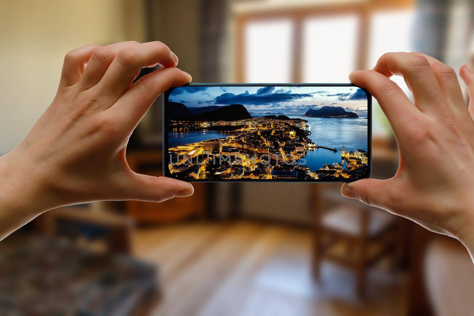 Norway city Aalesund on the screen. View famous tourist spots from home via smartphone. by 9parusnikov