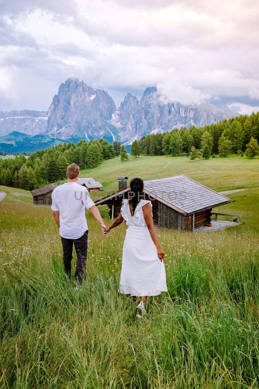 couple men and woman on vacation in the Dolomites Italy,Alpe di Siusi - Seiser Alm Dolomites, Trentino Alto Adige, South Tyrol, Italy by fokkebok
