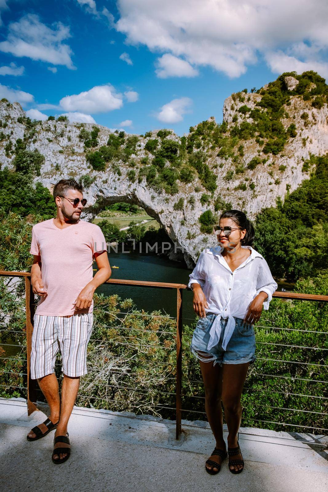 couple on the beach by the river in the Ardeche France Pont d Arc, Ardeche France,view of Narural arch in Vallon Pont D'arc in Ardeche canyon in France Europe