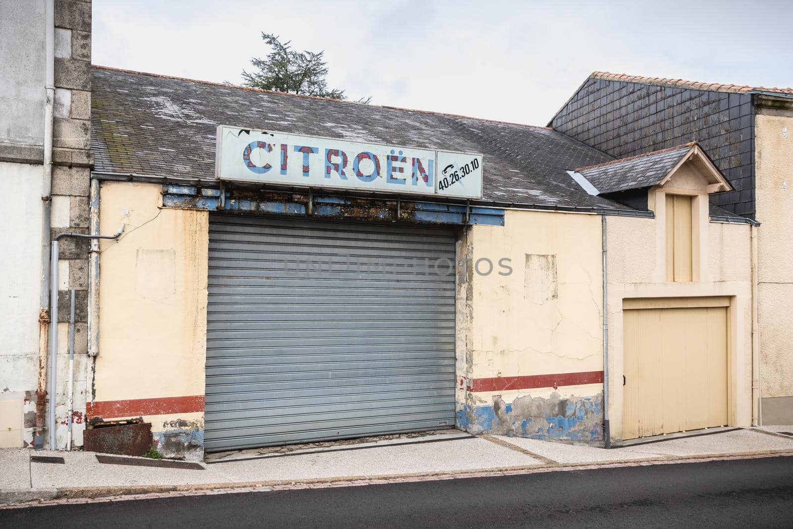 Lege, Vendee, France - September 21, 2020: Old garage bearing a vintage Citroen car brand sign on a fall day