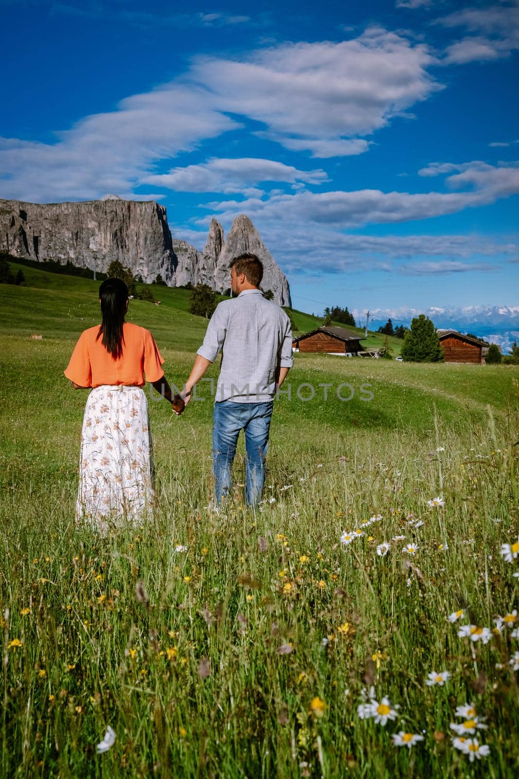 couple men and woman on vacation in the Dolomites Italy,Alpe di Siusi - Seiser Alm Dolomites, Trentino Alto Adige, South Tyrol, Italy by fokkebok