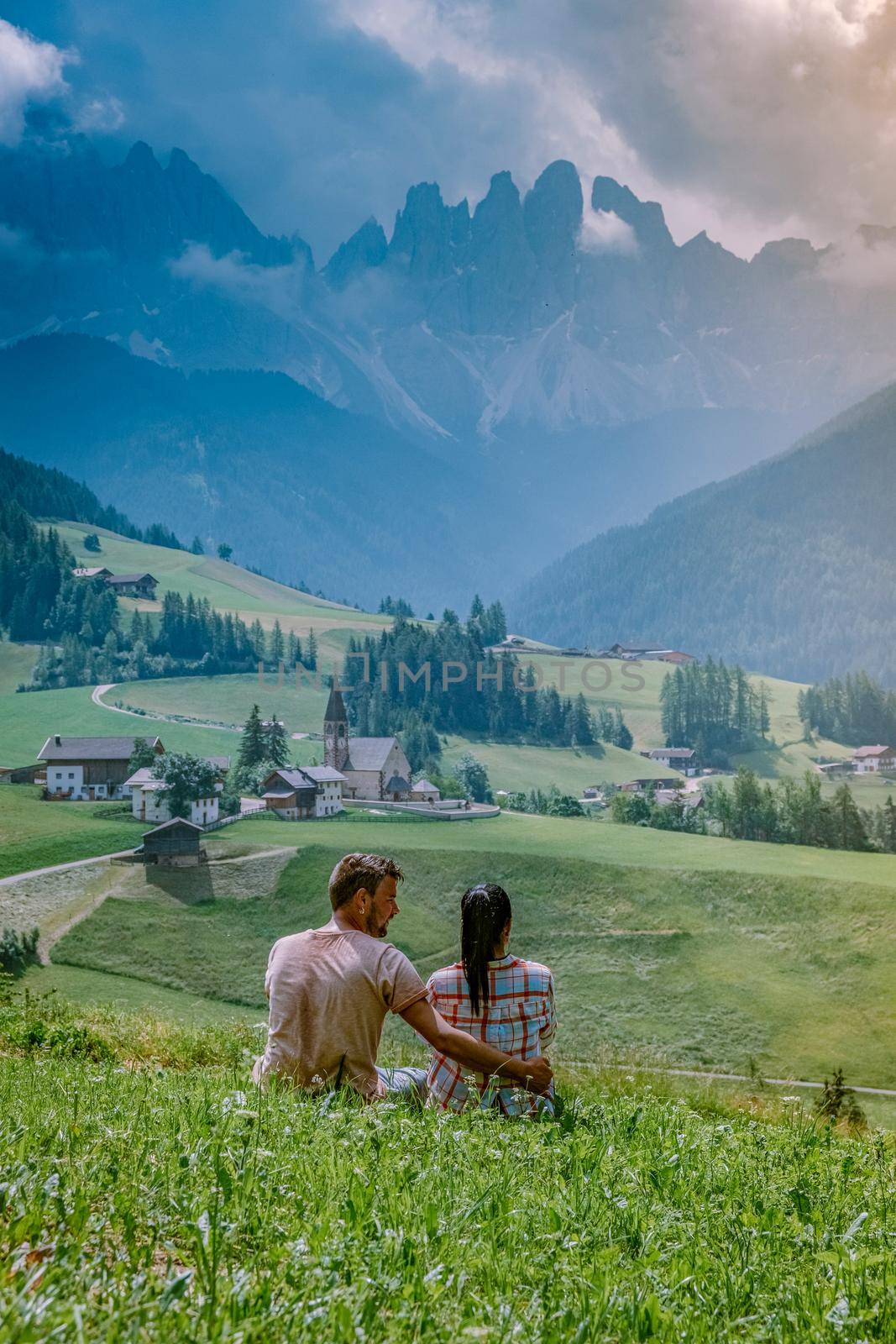 couple on vacation in the Dolomites Italy, Santa Magdalena Village in Dolomites area Italy Val di Funes by fokkebok