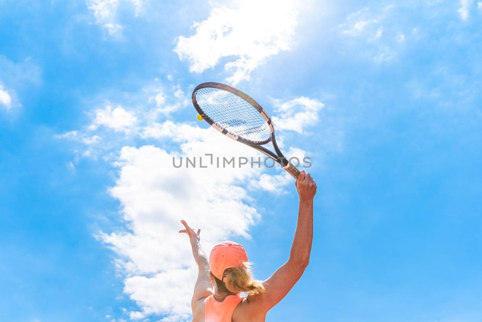tennis serve by a young woman on the court. view from below by Edophoto