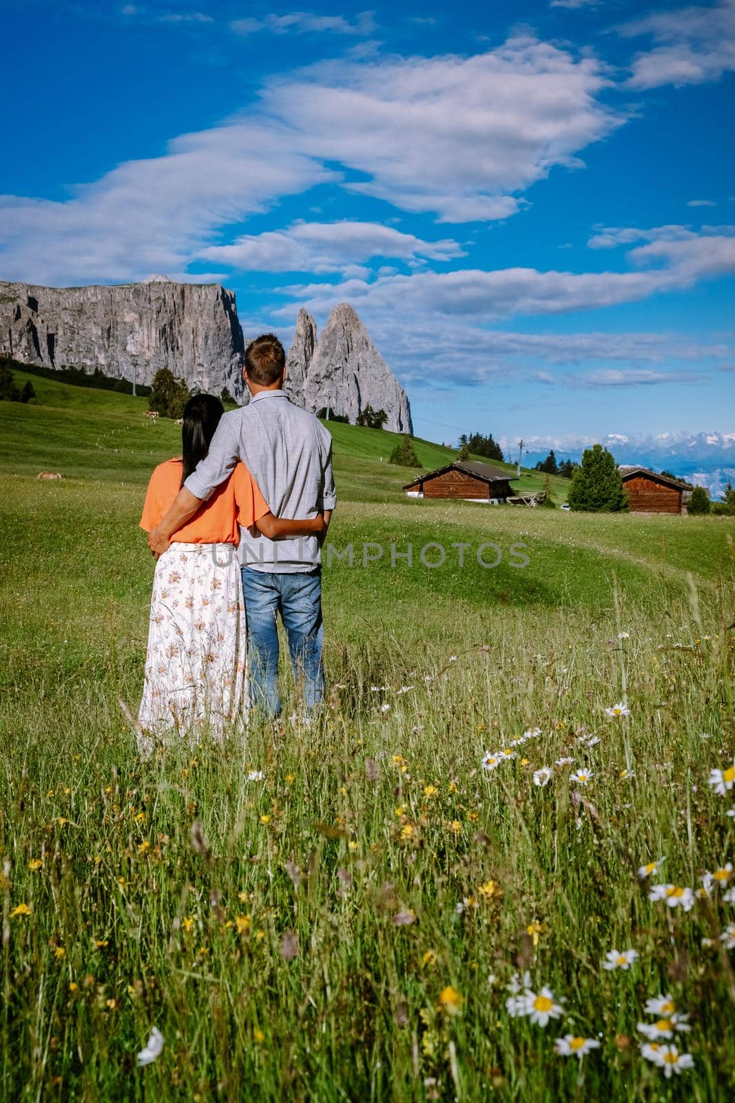 couple men and woman on vacation in the Dolomites Italy,Alpe di Siusi - Seiser Alm Dolomites, Trentino Alto Adige, South Tyrol, Italy by fokkebok