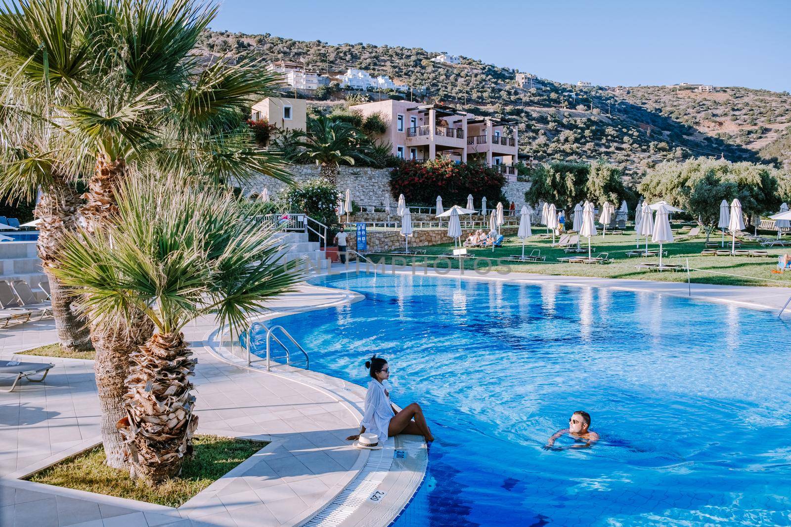 Crete Greece, Candia park village a luxury holiday village in Crete Greece by the ocean in traditional colors. Couple on vacation luxury resort