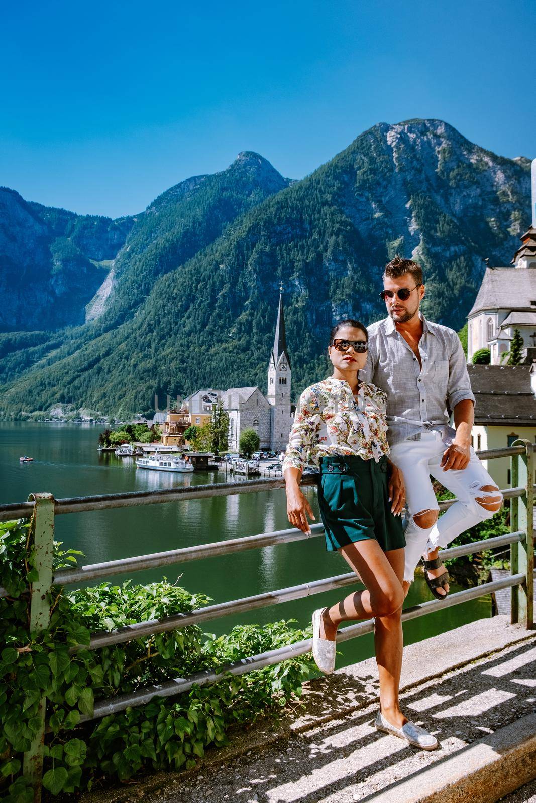 couple visit during summer vacation Hallstatt village on Hallstatter lake in Austrian Alps Austria Europe