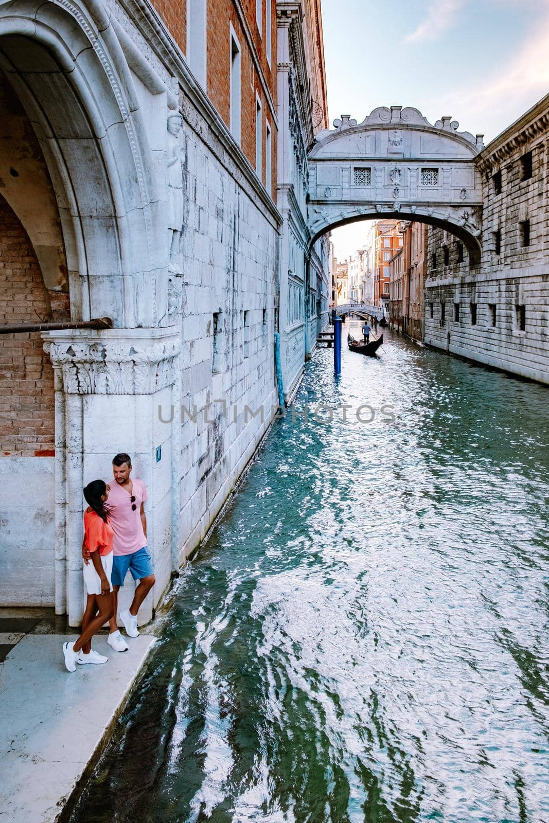 couple men and woman on a city trip to Venice Italy, colorful streets with canals Venice by fokkebok