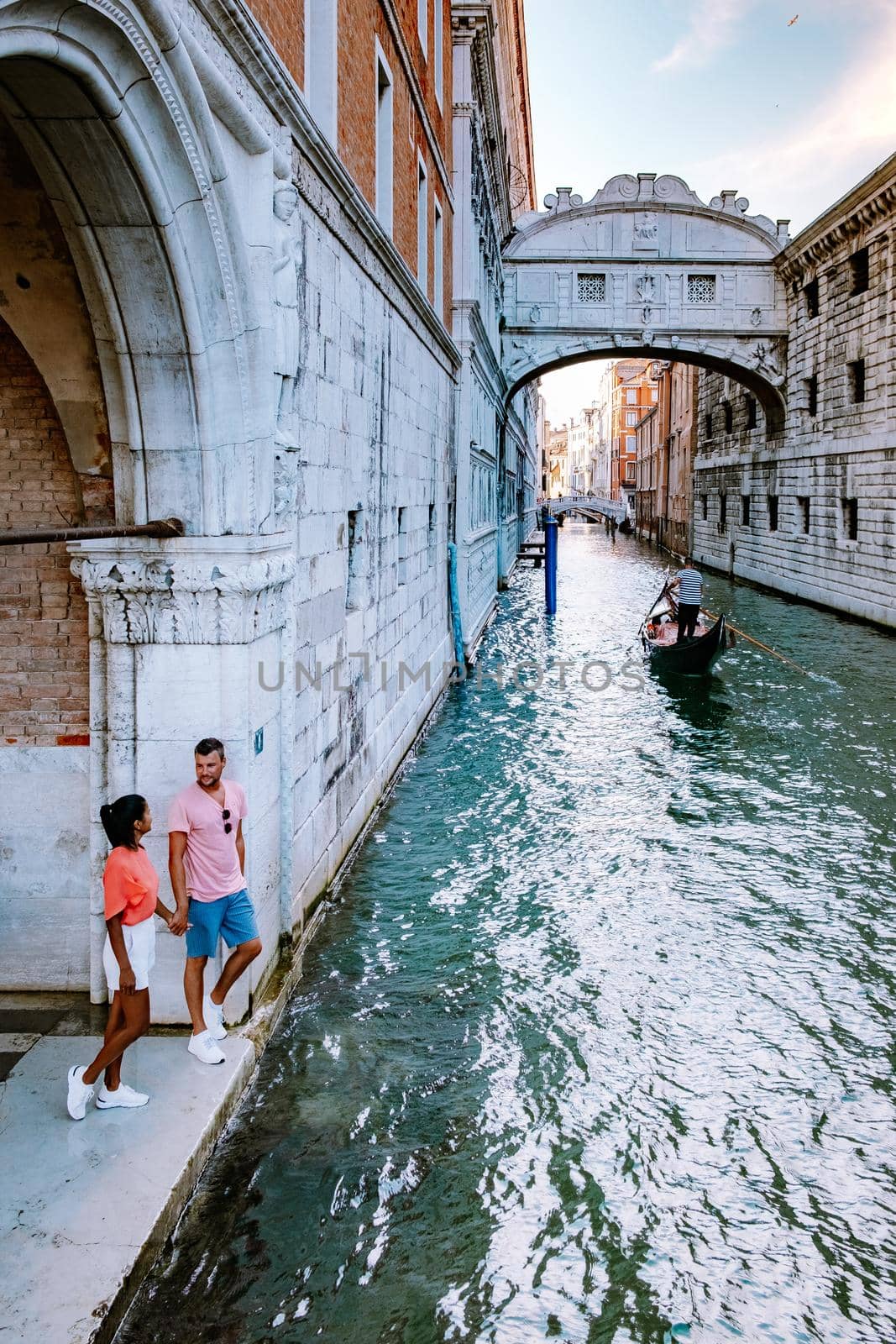 couple men and woman on a city trip to Venice Italy, colorful streets with canals Venice. Europe