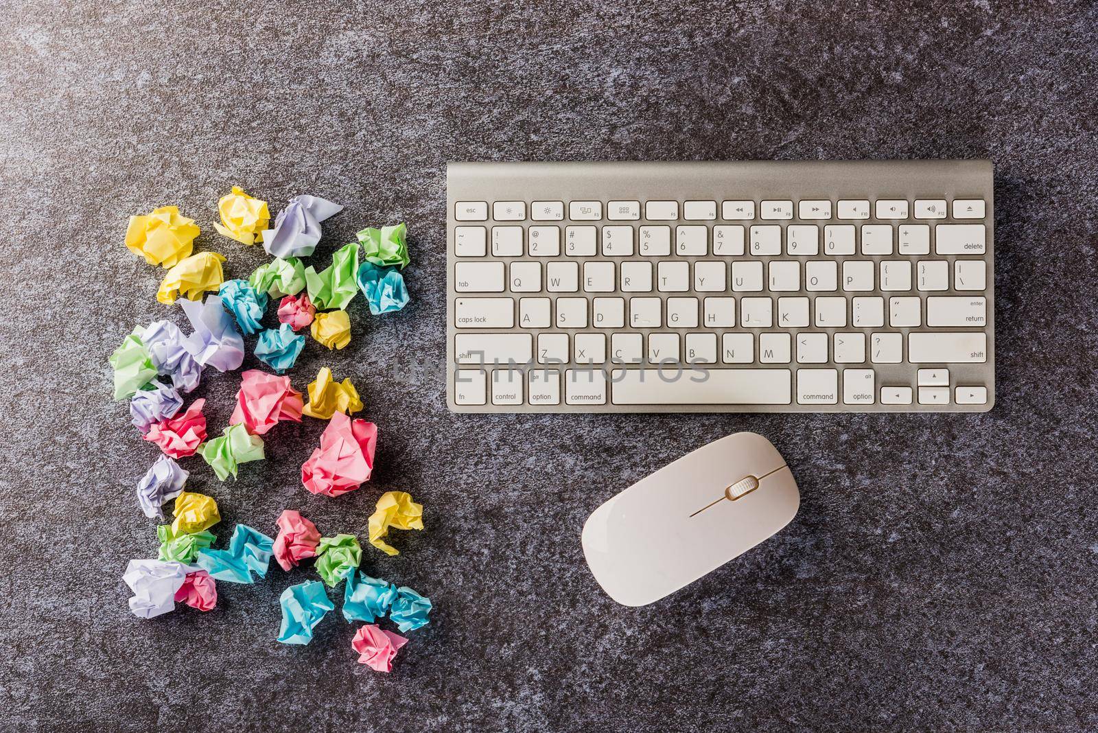 Top view flat lay of many crumpled paper stick note ball with computer keyboard on office desk concrete background no idea concept with copy space for text